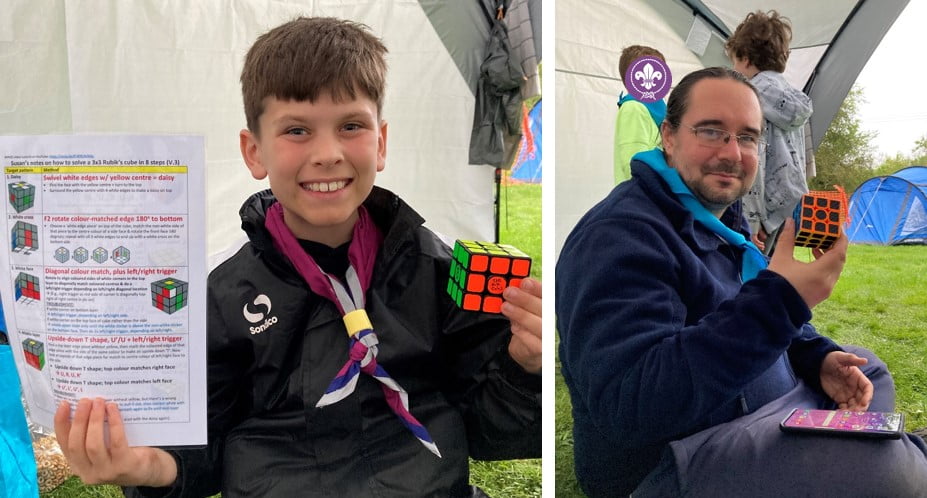 Photo of Cub and Leader with solved 3x3 Rubik's cube in hand. 