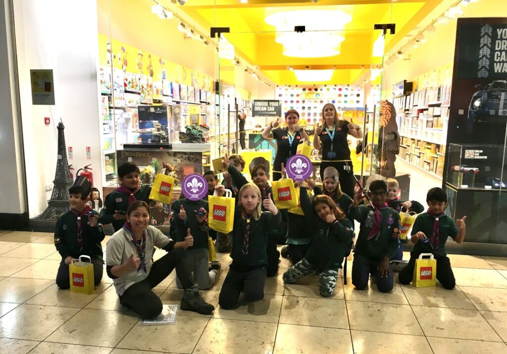 Group photo of 26th MK Coniston Cubs outside the Lego shop.