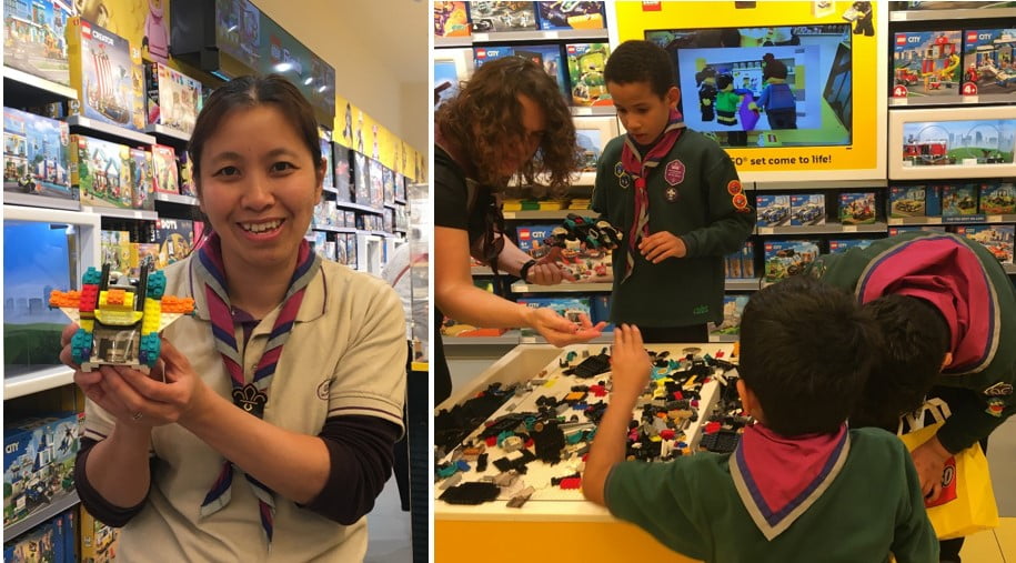 Photo of Leader with Lego car, Cubs busy building Lego cars.