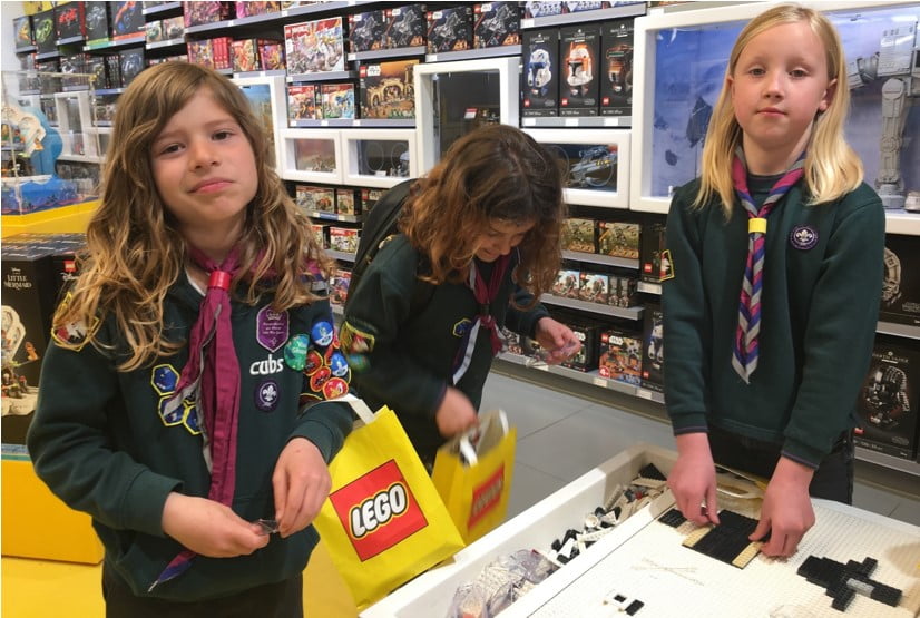 Photo of three Coniston Cubs at the Lego spaceship building base.
